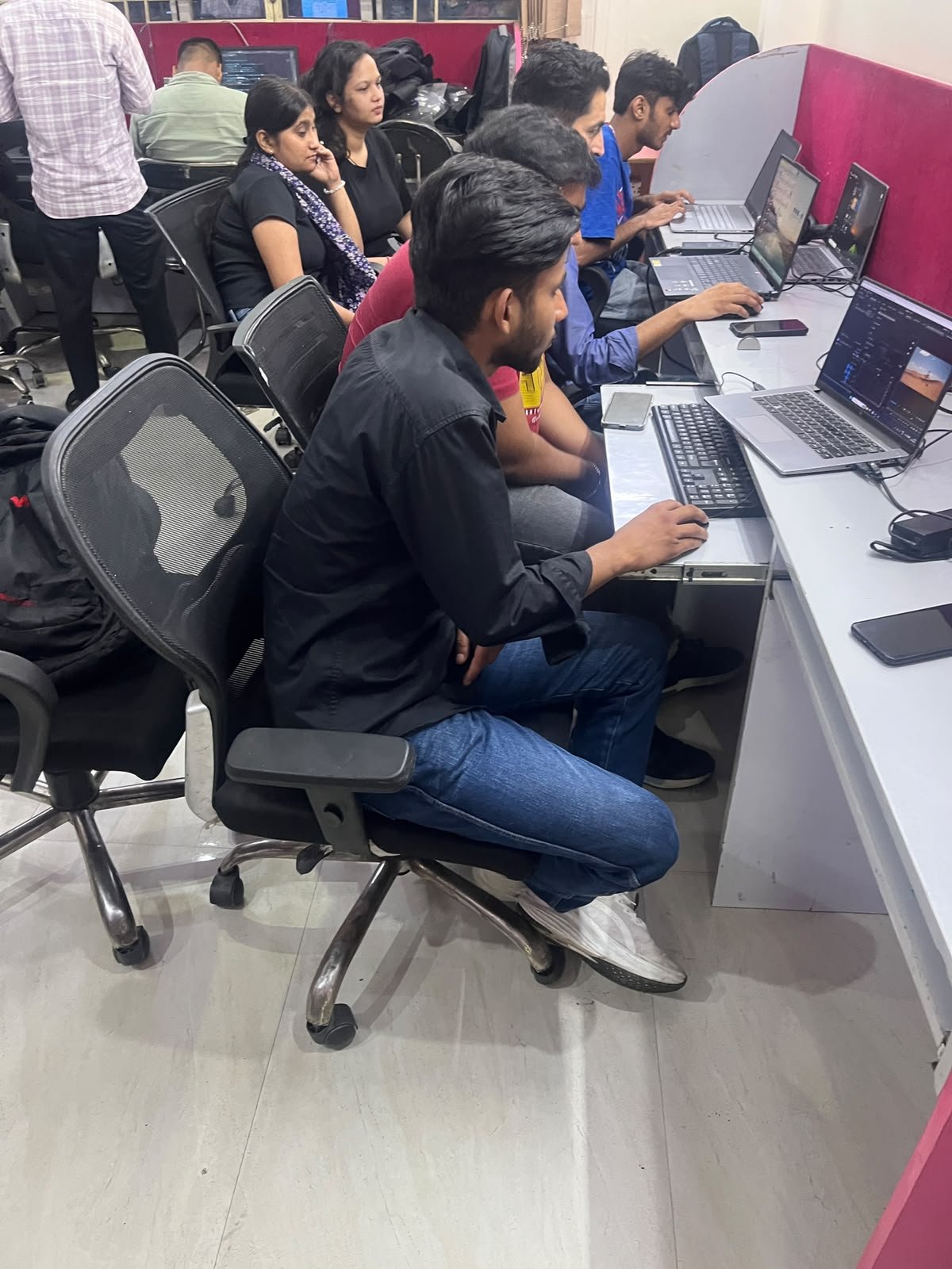 Students working at computer workstations in the lab