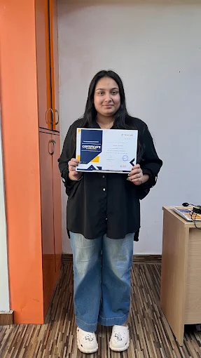 Student holding a course completion certificate